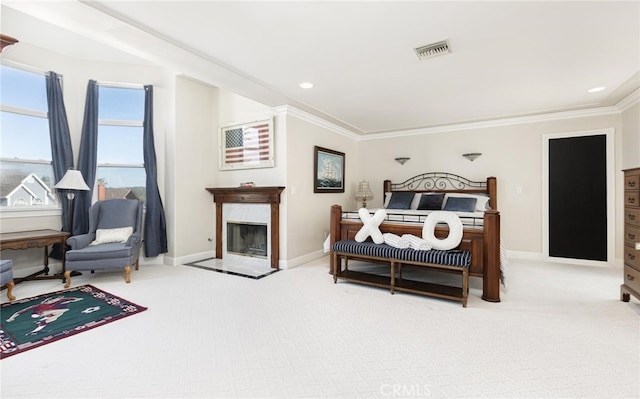 bedroom featuring visible vents, a premium fireplace, ornamental molding, light carpet, and baseboards