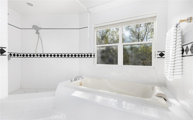 full bathroom featuring a garden tub and tiled shower