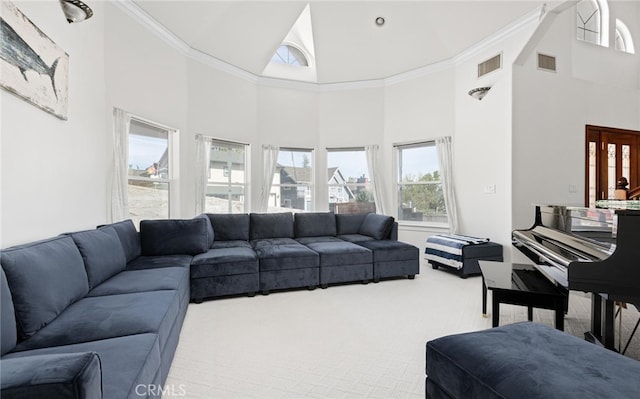 living room with visible vents, crown molding, a towering ceiling, and carpet flooring