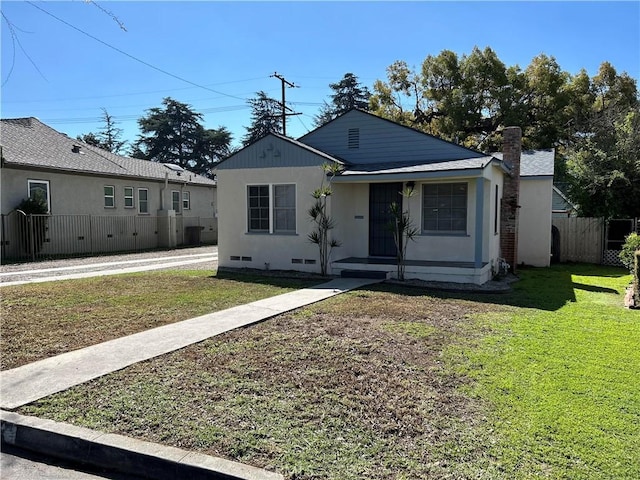 bungalow-style home featuring crawl space, a front yard, and fence