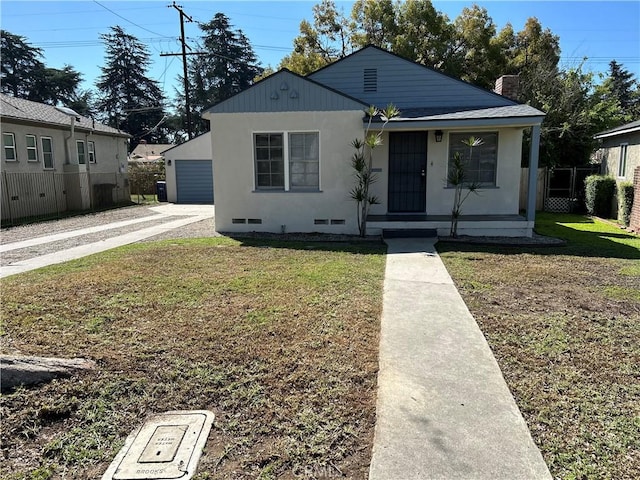 bungalow with stucco siding, covered porch, a front yard, crawl space, and fence