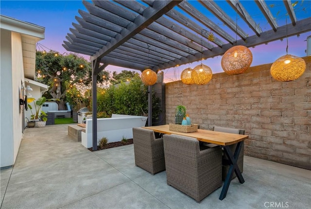 patio terrace at dusk with outdoor dining space and a pergola