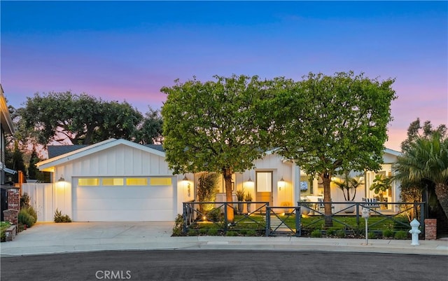 223 Robinhood Pl, Costa Mesa, CA 92627 - view of front facade featuring driveway, board and batten siding, fence private yard, and a garage