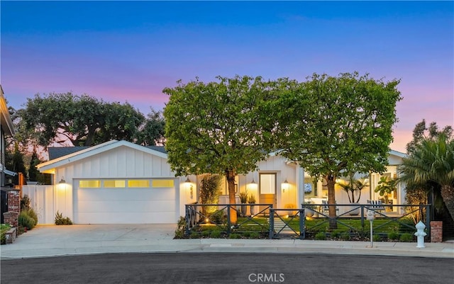 223 Robinhood Pl, Costa Mesa, CA 92627 - view of front of house with board and batten siding, a garage, and concrete driveway