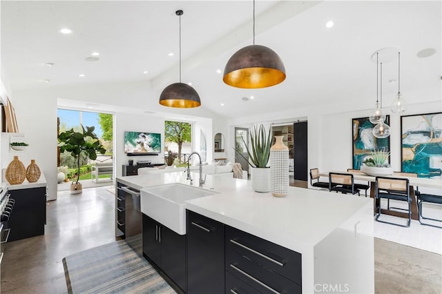 kitchen with light countertops, stainless steel dishwasher, open floor plan, a sink, and dark cabinetry