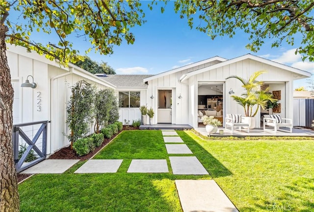 223 Robinhood Pl, Costa Mesa, CA 92627 - view of front of home featuring fence, board and batten siding, and a front lawn