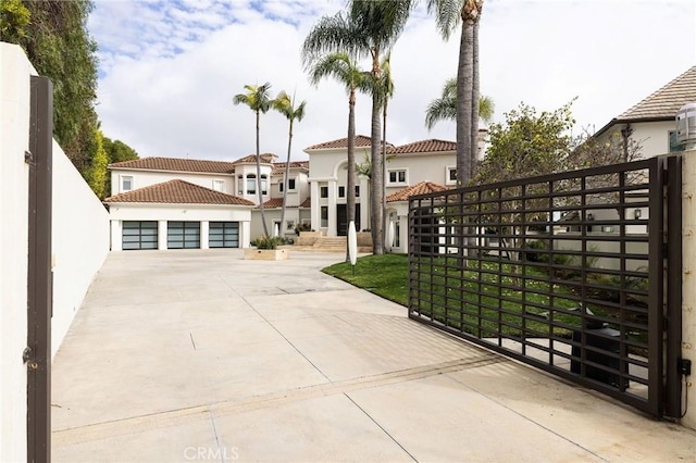 mediterranean / spanish-style home featuring an outbuilding, a tiled roof, and stucco siding