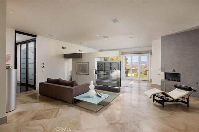 living area featuring visible vents and recessed lighting