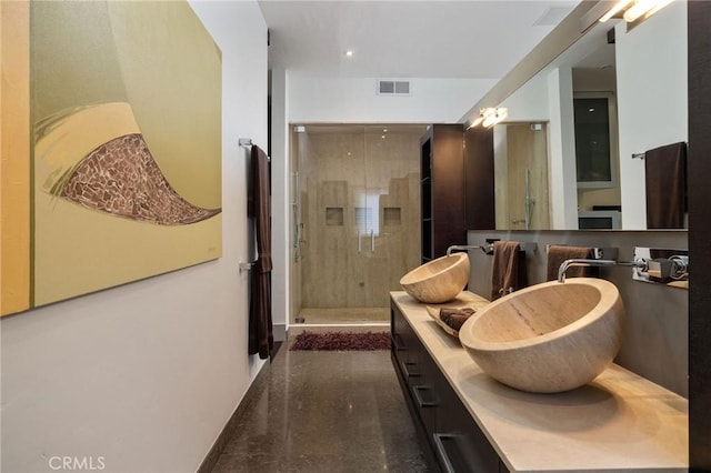 bathroom with visible vents, a stall shower, and vanity