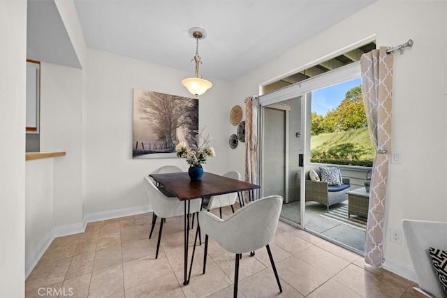 dining area with tile patterned floors and baseboards