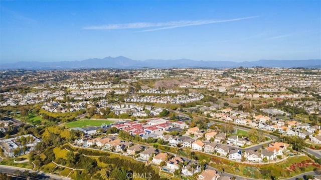 drone / aerial view featuring a residential view and a mountain view