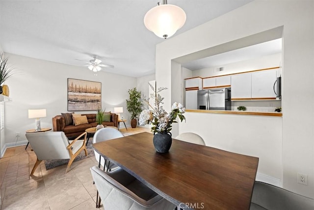 dining room featuring visible vents, a ceiling fan, and baseboards