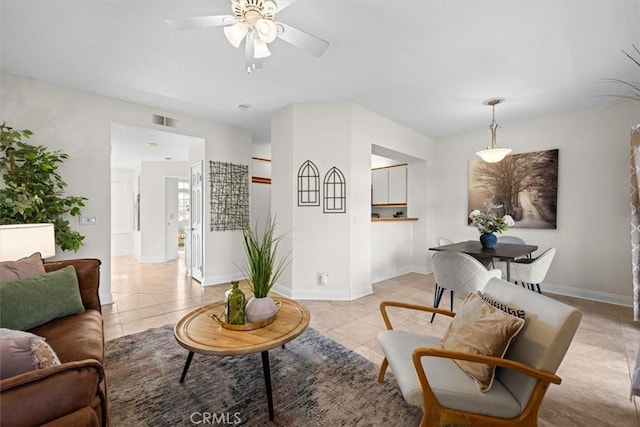 living room with light tile patterned floors, baseboards, visible vents, and ceiling fan