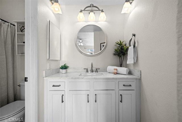 bathroom featuring toilet and vanity