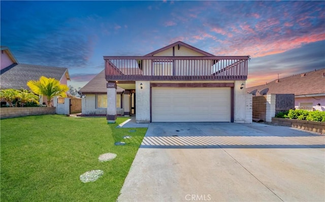 view of front facade featuring a garage, a yard, concrete driveway, and stucco siding