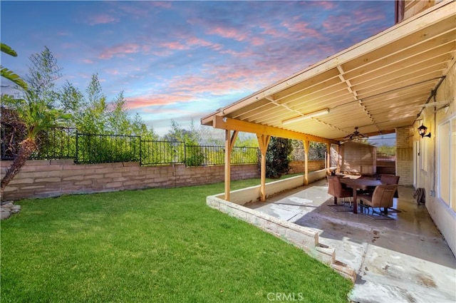 view of yard with a patio area, a fenced backyard, and outdoor dining area