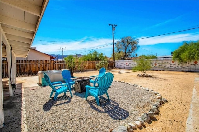 view of yard with a fenced backyard, a patio, and a fire pit