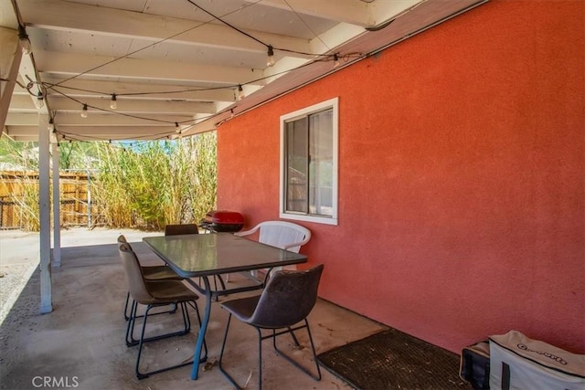 view of patio / terrace with outdoor dining space and fence