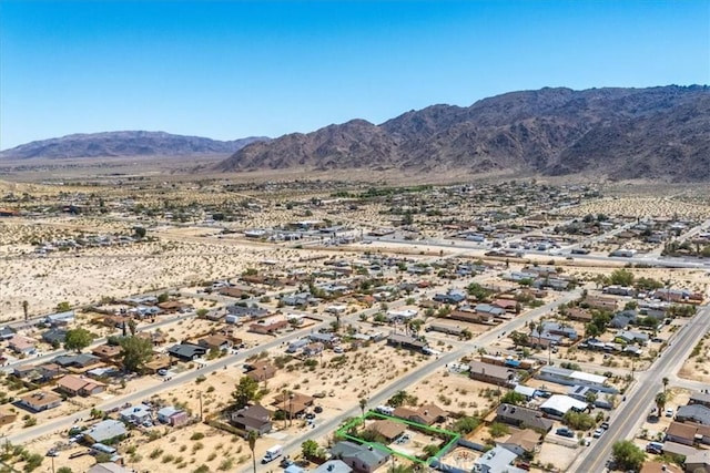 aerial view featuring a mountain view and view of desert