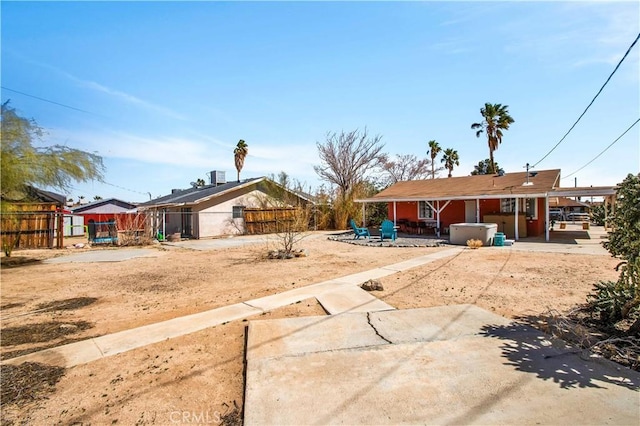 ranch-style house featuring fence and a patio