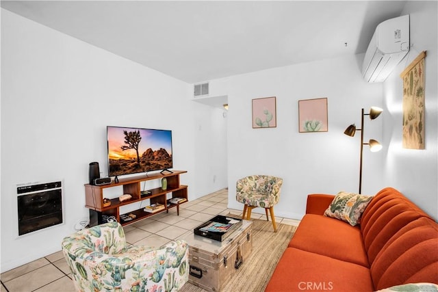 living area with a wall mounted air conditioner, visible vents, and tile patterned floors