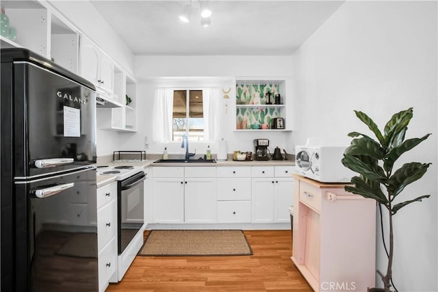 kitchen with open shelves, electric range, and freestanding refrigerator