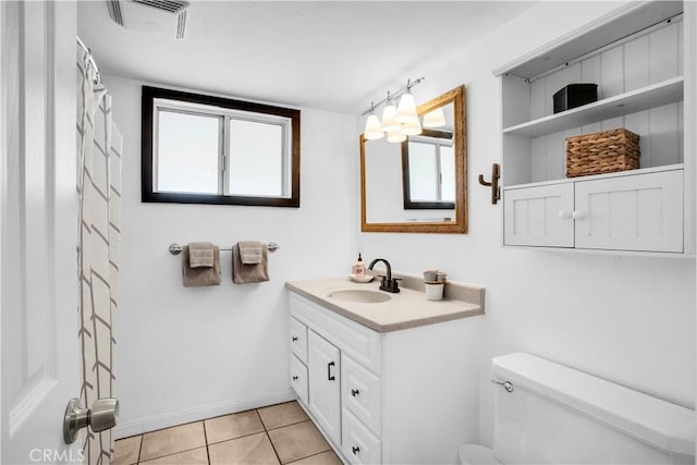 bathroom featuring visible vents, baseboards, toilet, tile patterned flooring, and vanity