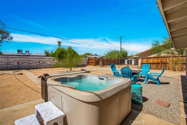 view of swimming pool with a fenced backyard, a patio, and a hot tub