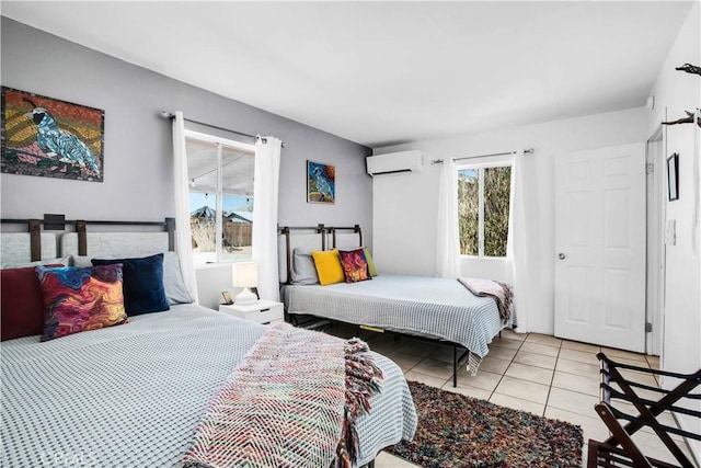 bedroom with light tile patterned floors and an AC wall unit