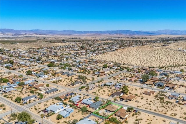 bird's eye view with a desert view and a mountain view