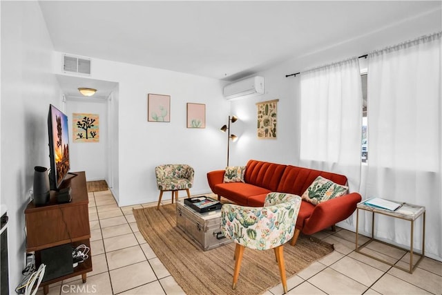 living area featuring a wall mounted AC, light tile patterned flooring, and visible vents