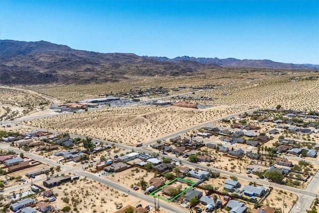 drone / aerial view featuring a desert view and a mountain view