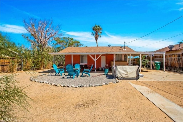 back of property featuring a patio area and fence