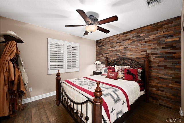 bedroom with ceiling fan, hardwood / wood-style floors, visible vents, and baseboards