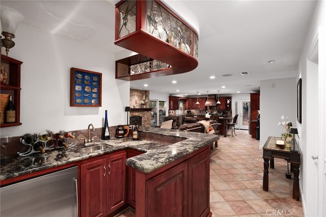 bar with indoor wet bar, recessed lighting, a sink, a stone fireplace, and dishwasher