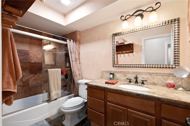 bathroom featuring toilet, tasteful backsplash, enclosed tub / shower combo, and vanity