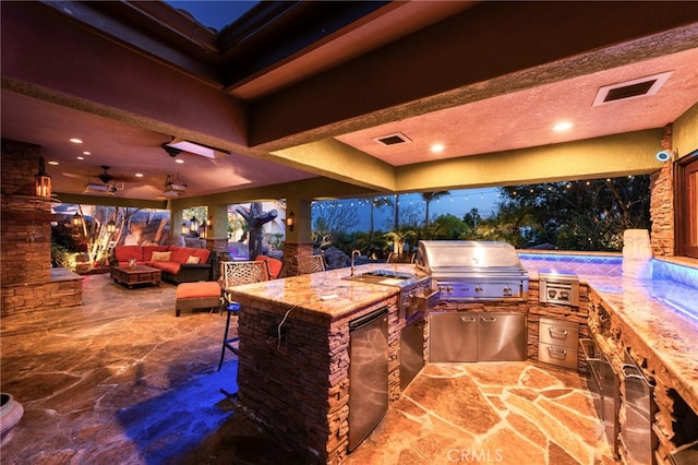 view of patio / terrace featuring an outdoor kitchen, visible vents, grilling area, and outdoor wet bar