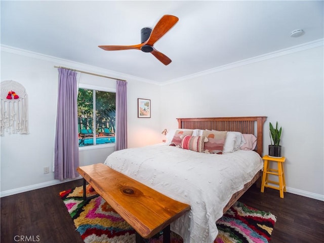 bedroom with ceiling fan, crown molding, baseboards, and wood finished floors