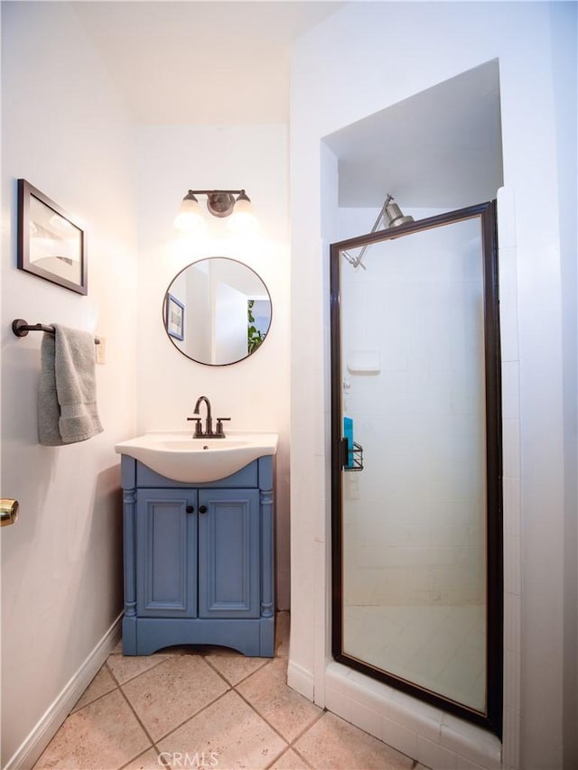 full bathroom featuring tile patterned flooring, a shower stall, vanity, and baseboards