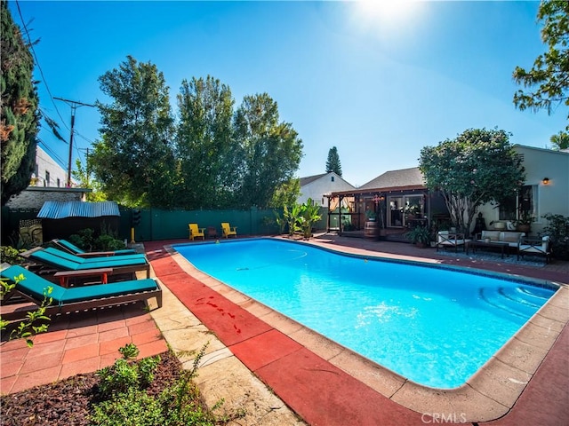 view of swimming pool with a fenced backyard, an outdoor hangout area, a fenced in pool, and a patio