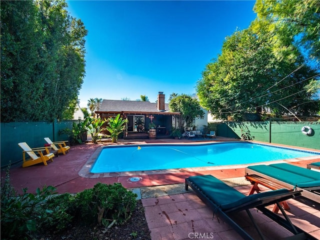 view of pool featuring a fenced backyard, a fenced in pool, and a patio