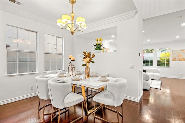 dining room featuring dark wood-style floors, ornamental molding, and baseboards