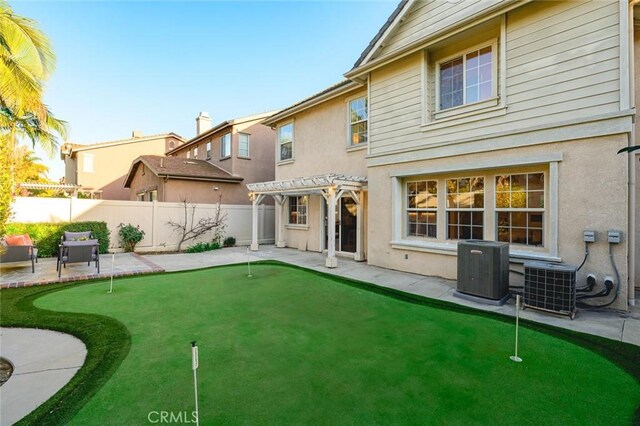 rear view of property with stucco siding, central AC, a pergola, and a patio