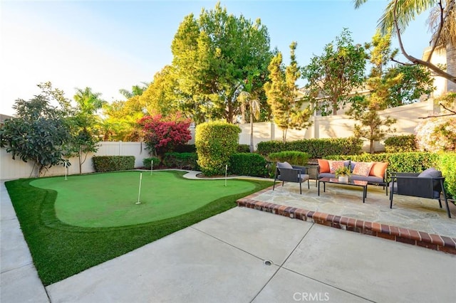 view of yard with a patio, a fenced backyard, and an outdoor living space