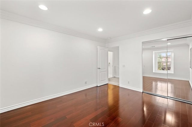 unfurnished bedroom featuring recessed lighting, crown molding, baseboards, and wood finished floors