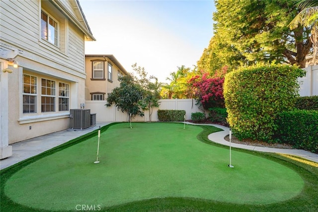 view of yard featuring central AC and a fenced backyard