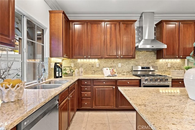 kitchen with ornamental molding, wall chimney range hood, a sink, and appliances with stainless steel finishes