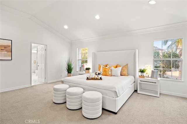 bedroom with crown molding, light colored carpet, vaulted ceiling, and baseboards