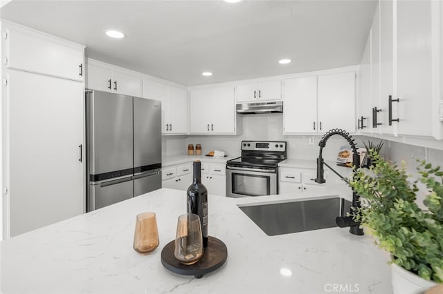 kitchen with stainless steel appliances, white cabinetry, a sink, light stone countertops, and under cabinet range hood