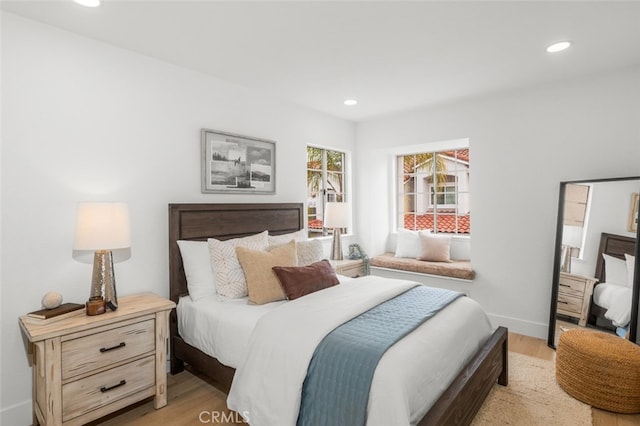 bedroom with recessed lighting, light wood-style flooring, and baseboards